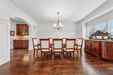 Large Dining Room with Arched Entry and hardwood f
