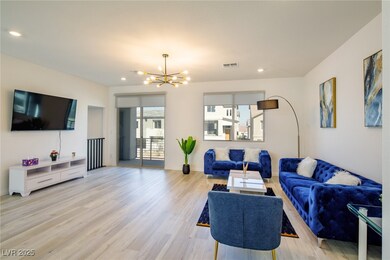 Living area with a chandelier, light wood-style fl