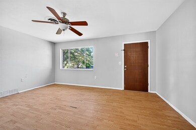 Empty room featuring light wood finished floors and ceiling fan