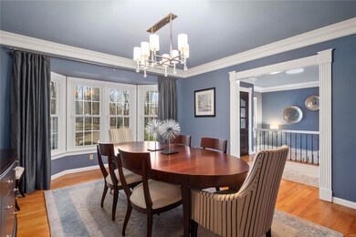 Dining room has hardwood flooring, crown molding, 
