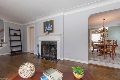 The Living Room with a graceful archway to the din