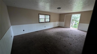 Unfurnished room with plenty of natural light, car