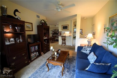 Living area with carpet floors and ceiling fan