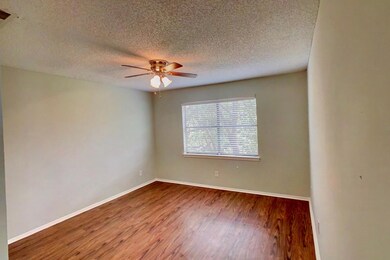 Unfurnished room with wood finished floors, a textured ceiling, and ceiling fan