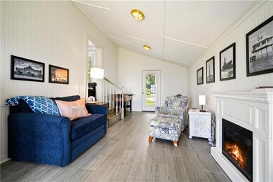 Living area featuring wood finished floors, a glas