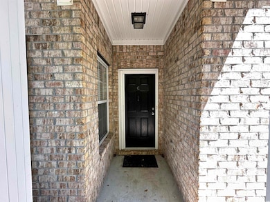 Property entrance with brick siding