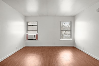 Spare room with healthy amount of natural light, light wood-style floors, and cooling unit