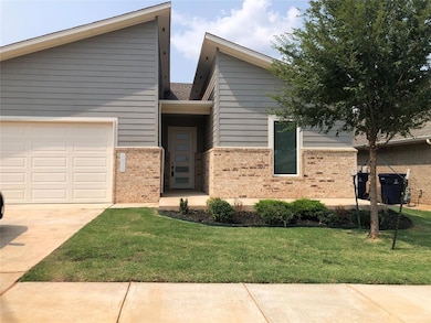 View of front of house with a garage and a front y