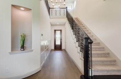 High ceiling entry area with beautiful iron railin