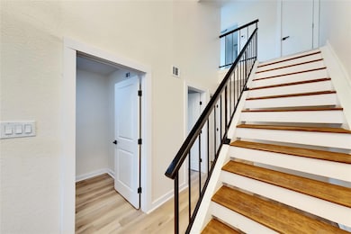 Stairway featuring wood finished floors and baseb