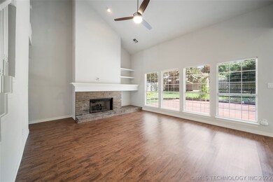 Vaulted Great Room w/FP & wall of windows.