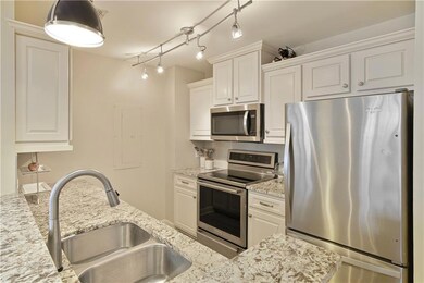 Kitchen featuring breakfast bar, custom backsplash, double sink & high end designer faucet Countertops are gorgeous.