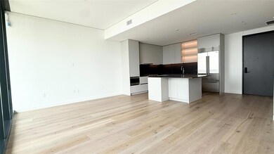 Kitchen with an island with sink, dark countertop
