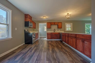 Kitchen with sink, stainless steel appliances, dar