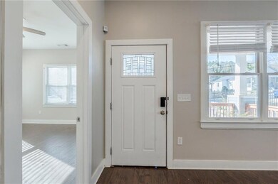 Entrance foyer featuring visible vents, dark wood 