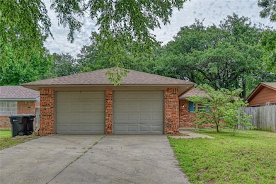 Garage featuring concrete driveway