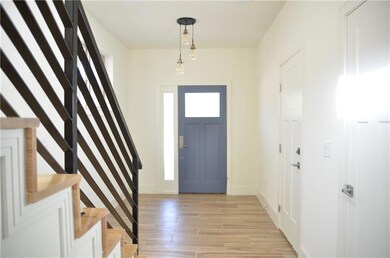 Foyer with stairs, light wood-type flooring, and 