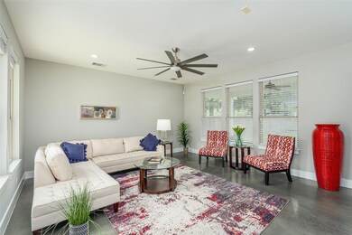 Living area featuring a ceiling fan, baseboards, 
