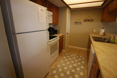 Galley kitchen with appliances that remain and a p