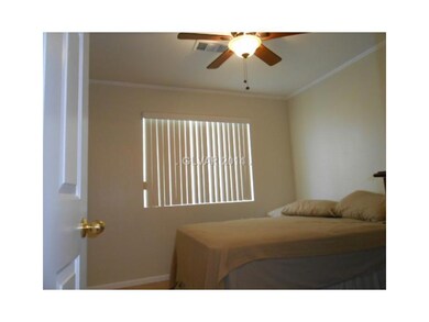 Property Photo. Secondary bedroom has ceiling fan