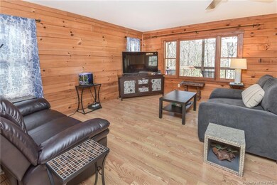 Greatroom has rich wood walls, Pergo and views