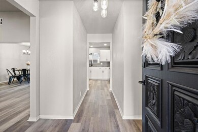 Hallway with hardwood / wood-style flooring and an