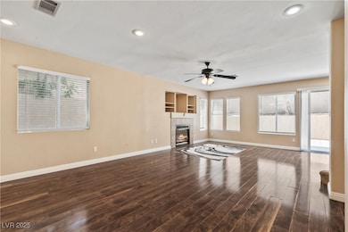 Unfurnished living room featuring baseboards, a ce
