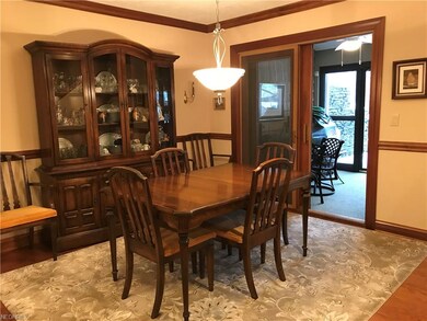 Formal dining room with hardwood floors, crown mol