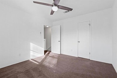 Unfurnished bedroom with ceiling fan, carpet, and