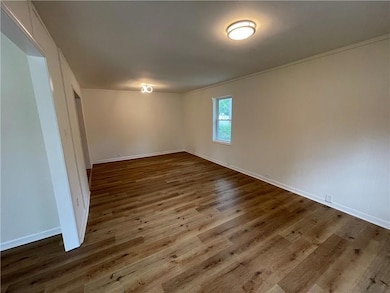 Unfurnished room with wood finished floors, orname