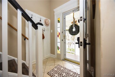 Foyer entrance featuring light tile patterned floo