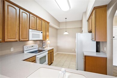Kitchen boasting lovely cabinets and neutral color