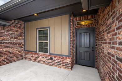 View of exterior entry with brick siding