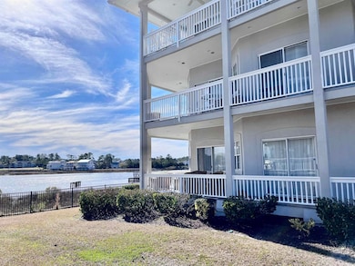 Exterior space featuring a water view, a balcony, and fence