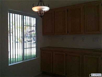 Breakfast nook off kitchen with built-in cabinets.