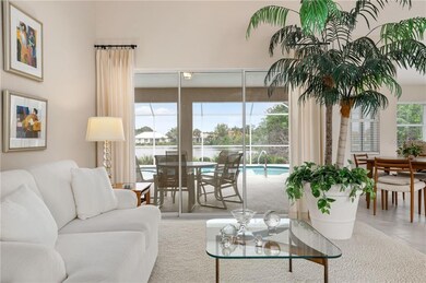 Living room with sliders to lanai and pool