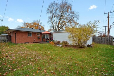 Back of house featuring brick siding and a deck