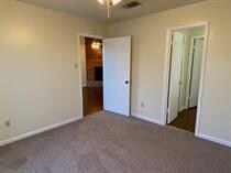 Unfurnished bedroom featuring baseboards and carpe