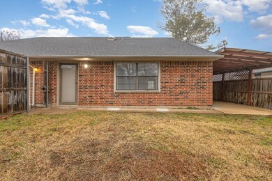 Rear view of house featuring a yard and a patio ar
