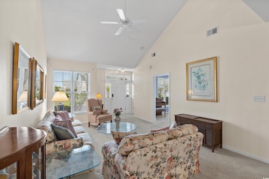 Living room with baseboards, high vaulted ceiling,