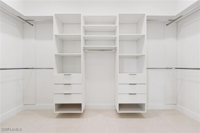 Spacious closet featuring light tile patterned flo