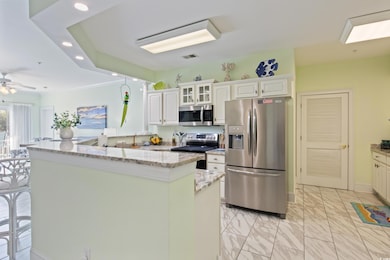 Kitchen featuring visible vents, marble finish floor, stainless steel appliances, recessed lighting, and a center island