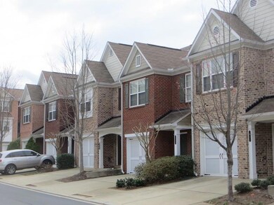 Townhome / multi-family property featuring brick s