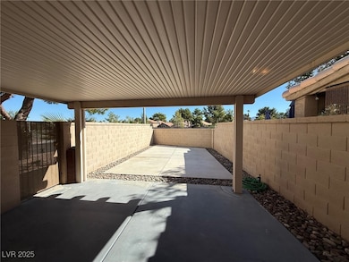 Fenced backyard with a patio