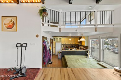 LIvingroom facing loft and kitchen