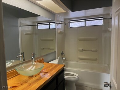 Bathroom with toilet, shower / bath combination, a