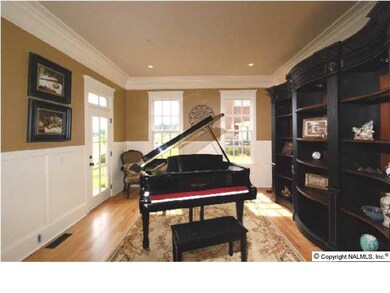THE FORMAL LIVING ROOM IS 15 X 14 WITH HARDWOOD FLOORS, WAINSCOTING, HEAVY CROWN MOLDING AND RECESSED LIGHTING. NOTICE TOO, THE BEAUTIFUL WOODWORK AROUND THE DOORS AND WINDOWS.