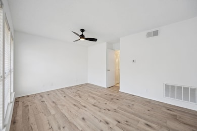 Spare room featuring light wood-style floors and ceiling fan