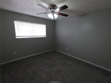 Empty room featuring baseboards, a ceiling fan, da