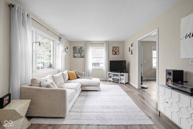 living area featuring baseboards and wood finished floors